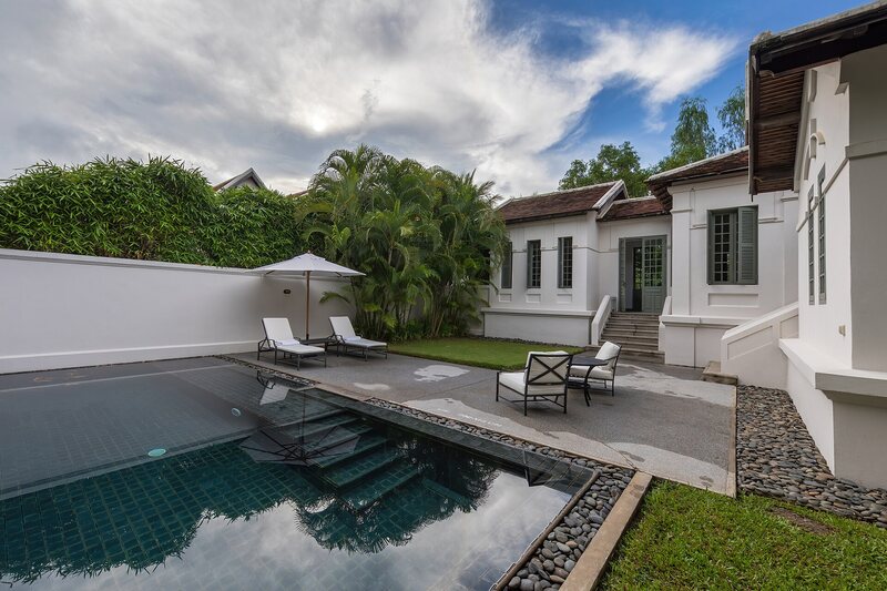 Modern pool with lounge chairs and white architecture